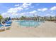 Large community pool with several lounge chairs and umbrellas, set against a sunny blue sky at 2020 Santa Maria St., Myrtle Beach, SC 29579