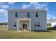 Back exterior of home with a patio seating area overlooking the expansive backyard at 210 Bald Cypress Way, Conway, SC 29527