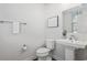 White half bath features a pedestal sink and funny wall art at 2557 Pete Dye Dr. # 403, North Myrtle Beach, SC 29582