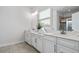 A bright bathroom features double vanity, framed mirrors, and a garden tub at 2557 Pete Dye Dr. # 403, North Myrtle Beach, SC 29582