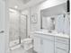 Modern bathroom with a sleek vanity, white cabinets, tiled shower and large mirror at 2557 Pete Dye Dr. # 403, North Myrtle Beach, SC 29582