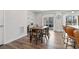 The dining area features a wooden table with seating for six and sliding doors leading to a balcony at 2557 Pete Dye Dr. # 403, North Myrtle Beach, SC 29582