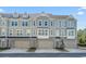 Attractive townhomes with a stone facade and covered entryways, each featuring an attached garage and landscaped front at 2557 Pete Dye Dr. # 403, North Myrtle Beach, SC 29582