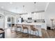 Modern kitchen features white cabinets, stainless steel appliances, an island with bar seating, and access to an outdoor patio at 2557 Pete Dye Dr. # 403, North Myrtle Beach, SC 29582