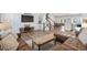 Open-concept living area with a modern entertainment center, staircase, and seamlessly connected to dining and kitchen spaces at 2557 Pete Dye Dr. # 403, North Myrtle Beach, SC 29582