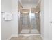 Modern tiled shower with glass doors and a built-in bench in this bathroom at 2557 Pete Dye Dr. # 403, North Myrtle Beach, SC 29582