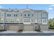 Three-story townhomes featuring attached garages and neutral exterior color schemes at 2557 Pete Dye Dr. # 403, North Myrtle Beach, SC 29582