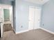 Bright bedroom featuring an open doorframe and a closet with sliding doors at 3461 Holly Loop, Conway, SC 29527