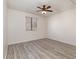 A simple room with gray wood laminate flooring and a window to bring in natural light at 3555 Highway 544 # 17F, Conway, SC 29526