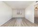 A simple room with gray wood laminate flooring and a window to bring in natural light at 3555 Highway 544 # 17F, Conway, SC 29526