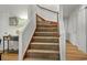 Carpeted staircase with white banisters and wood handrail at 402 13Th Ave. S, North Myrtle Beach, SC 29582