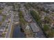 Overhead view of a neighborhood with condos, single-Gathering homes, a pond, and lush greenery at 4179 Hibiscus Dr. # 303, Little River, SC 29566