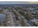 Aerial view of a charming community featuring condo buildings, homes, a pond, and scenic coastal views at 4179 Hibiscus Dr. # 303, Little River, SC 29566