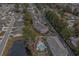 Elevated view of a charming community featuring condo buildings, a pool, lush trees, and a serene pond at 4179 Hibiscus Dr. # 303, Little River, SC 29566