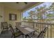 Outdoor balcony with a table set, perfect for al fresco dining and overlooking the lush landscape at 4179 Hibiscus Dr. # 303, Little River, SC 29566