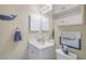 Charming bathroom with white vanity, decorative whale accents and cabinet storage at 4179 Hibiscus Dr. # 303, Little River, SC 29566