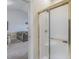 Bathroom featuring a glass shower with gold trim and an attached living room at 4179 Hibiscus Dr. # 303, Little River, SC 29566