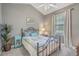 Cozy bedroom with iron bed frame, side table, and window with natural light at 4179 Hibiscus Dr. # 303, Little River, SC 29566