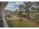 Balcony view shows lush landscaping, a pond, community pool and clubhouse at 4179 Hibiscus Dr. # 303, Little River, SC 29566