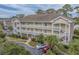 An aerial view of the building offers a glimpse into the exterior with ample parking spaces at 4179 Hibiscus Dr. # 303, Little River, SC 29566