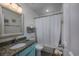 Bathroom with a granite countertop, bathtub with shower and white wall cabinet at 4406 N Ocean Blvd. # A-1, North Myrtle Beach, SC 29582