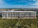 Gorgeous condo building with white balconies, offering serene views of the marsh and ocean at 4406 N Ocean Blvd. # A-1, North Myrtle Beach, SC 29582