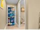 Hallway leading to the bathroom has a blue shelf filled with decorative rolled beach towels and a Paradise sign at 4604 S Ocean Blvd. S # 1B, North Myrtle Beach, SC 29582