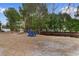 Lush backyard with serene pond view and inviting blue Adirondack chairs at 470 Springlake Dr., Myrtle Beach, SC 29579