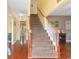 Welcoming foyer with a staircase featuring wood handrails and white balusters leading to the upper level at 470 Springlake Dr., Myrtle Beach, SC 29579