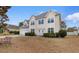 Charming two-story home featuring blue shutters, an attached two-car garage, and a well-maintained lawn at 470 Springlake Dr., Myrtle Beach, SC 29579