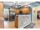 Kitchen featuring stainless appliances, stone accent wall, breakfast bar, and tile flooring at 470 Springlake Dr., Myrtle Beach, SC 29579