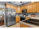 Well-equipped kitchen featuring stainless steel appliances, wooden cabinetry, and ample counter space at 470 Springlake Dr., Myrtle Beach, SC 29579