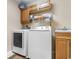 Functional laundry room with washer, dryer, and wooden cabinets for storage at 470 Springlake Dr., Myrtle Beach, SC 29579