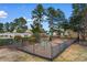 Community playground area with climbing structure, slide, and swings surrounded by mature trees and a black metal fence at 470 Springlake Dr., Myrtle Beach, SC 29579