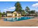 Community pool area with a large pool, pool house, white pergola, and lounge chairs for residents at 470 Spring Lake Dr., Myrtle Beach, SC 29579