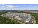 Aerial view of a residential neighborhood with community pond, manicured lawns, and mature trees at 4865 Luster Leaf Circle # 304, Myrtle Beach, SC 29577