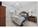 Bedroom with neutral walls, carpet, ceiling fan, wood furniture, and a window with natural light at 4865 Luster Leaf Circle # 304, Myrtle Beach, SC 29577