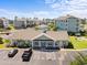 Aerial view of the clubhouse with ample parking surrounded by lush landscaping and residential buildings at 4865 Luster Leaf Circle # 304, Myrtle Beach, SC 29577