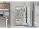 Inviting entryway featuring a storm door to let light in, neutral decor, and a stainless steel refrigerator at 4865 Luster Leaf Circle # 304, Myrtle Beach, SC 29577