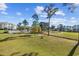 Exterior shot of lush green space and mature trees with golf course and pool in the distance at 4865 Luster Leaf Circle # 304, Myrtle Beach, SC 29577