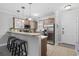 Modern kitchen featuring a breakfast bar with seating, stainless appliances, tile floors, and wooden cabinets at 4865 Luster Leaf Circle # 304, Myrtle Beach, SC 29577