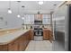 Well-equipped kitchen featuring wood cabinets, stainless appliances, a breakfast bar, and stylish pendant lighting at 4865 Luster Leaf Circle # 304, Myrtle Beach, SC 29577