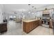 Open-concept kitchen featuring wood cabinets, stainless appliances, tile floors, and a view of the spacious living room at 4865 Luster Leaf Circle # 304, Myrtle Beach, SC 29577