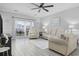 Inviting living room featuring hardwood floors, comfortable seating, neutral paint, a ceiling fan, and balcony access at 4865 Luster Leaf Circle # 304, Myrtle Beach, SC 29577