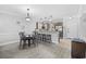 Open-concept living area featuring a modern kitchen, dining table, and access to a balcony with outdoor seating at 4865 Luster Leaf Circle # 304, Myrtle Beach, SC 29577