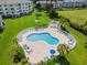 Aerial view of the pool with blue lounge chairs, surrounded by landscaped grounds at 4865 Luster Leaf Circle # 304, Myrtle Beach, SC 29577
