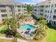 Aerial view of the community pool area, equipped with lounge chairs and umbrellas at 4865 Luster Leaf Circle # 304, Myrtle Beach, SC 29577