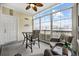 Cozy sunroom featuring wicker furniture, ceiling fan and expansive windows with neighborhood view at 4865 Luster Leaf Circle # 304, Myrtle Beach, SC 29577