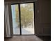 Balcony view with sliding glass doors overlooking lush trees, a calming outdoor connection at 5001 Little River Rd. # E-312, Myrtle Beach, SC 29577