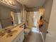 Clean bathroom features a combination tub and shower with sunflower themed shower curtain at 5001 Little River Rd. # E-312, Myrtle Beach, SC 29577